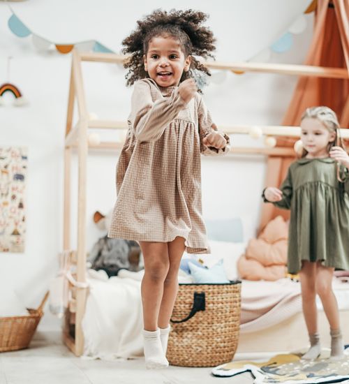 child jumping up in the air at daycare